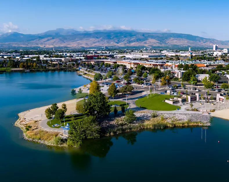 Sparks, Nevada USA - September 21, 2023: Aerial view of the Sparks Marina Park, Reno and Sparks cityscape with Mt. Rose, Slide Mountain in the background during early autumn.